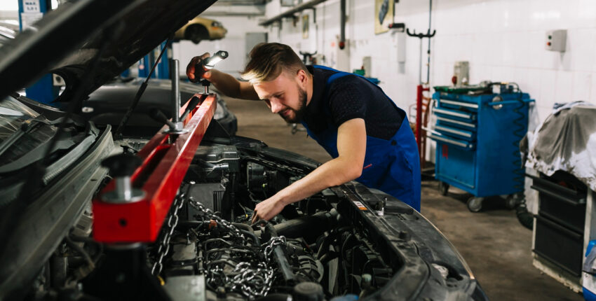 Mechanic inspecting engine bay of the vehicle