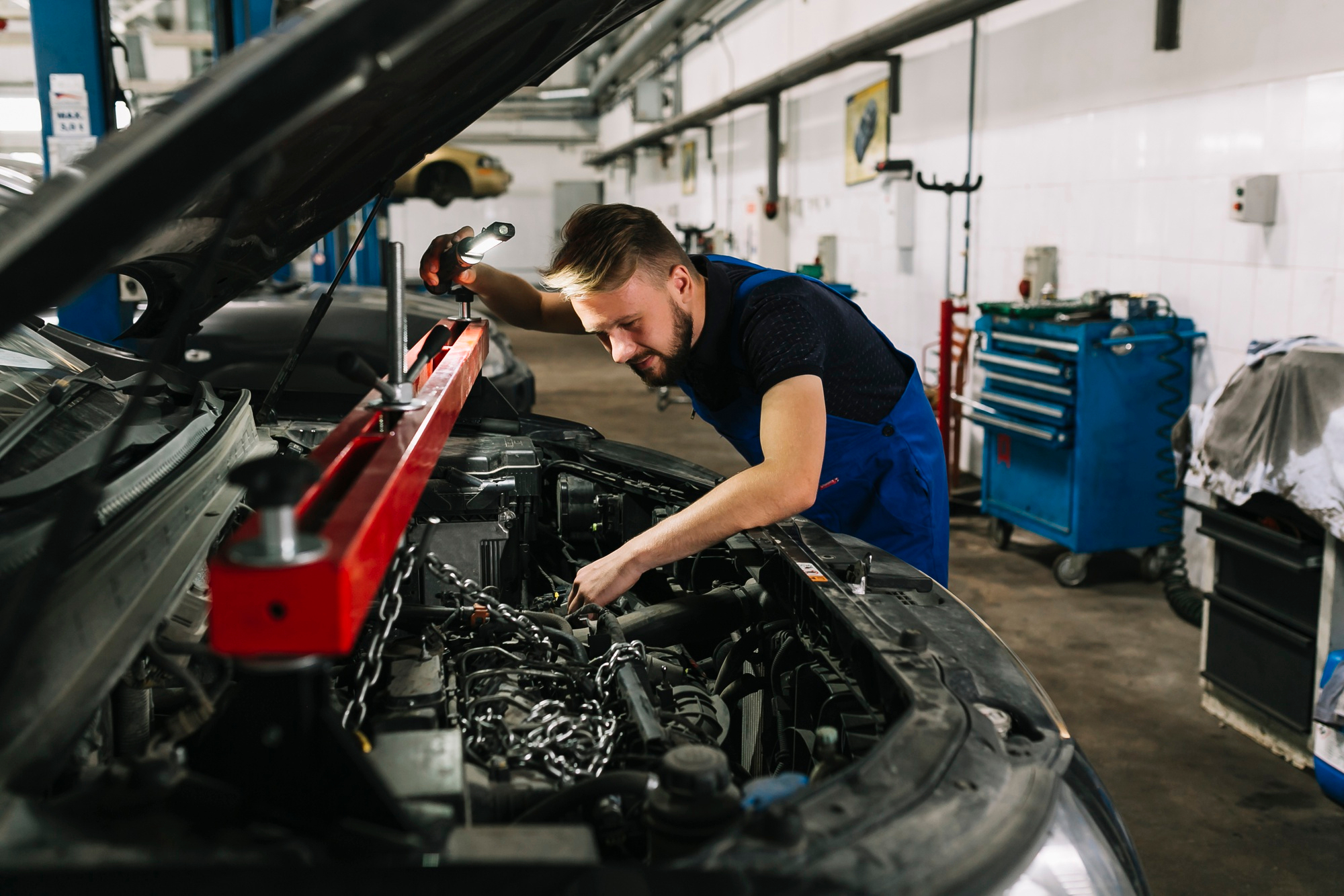 Mechanic inspecting engine bay of the vehicle